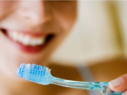 woman holding toothbrush 