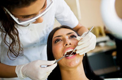 Hygienist looking at teeth